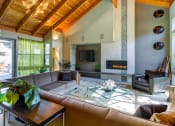Thumbnail 18 of 25 - a large living room with a large leather couch and a glass coffee table at The Lakes Apartments, Bellevue, 98007