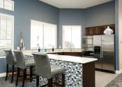 Thumbnail 25 of 29 - a kitchen with a bar and a stainless steel refrigerator at Veranda at Centerfield, Houston, TX