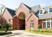 Thumbnail 29 of 29 - the front of a brick house with a driveway and a palm tree at Veranda at Centerfield, Houston, TX, 77070