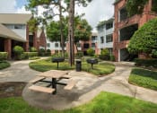 Thumbnail 22 of 29 - our apartments have a spacious courtyard with a picnic table and grills at Veranda at Centerfield, Houston, 77070