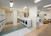 Thumbnail 19 of 21 - A laundry room with washers and dryers at Skye at Belltown Apartments, Seattle