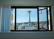 Thumbnail 3 of 21 - A view of the Space Needle from a window at Skye at Belltown Apartments, Seattle, WA