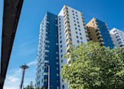 Thumbnail 21 of 21 - A tall building with a blue sky in the background at Skye at Belltown Apartments, Seattle, WA