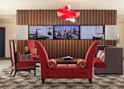 Thumbnail 17 of 21 - A modern living room with a large screen TV and comfortable seating at Skye at Belltown Apartments, Seattle, 98121