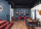 Thumbnail 14 of 21 - A dining room with a wooden table and chairs at Skye at Belltown Apartments, Seattle, WA 98121