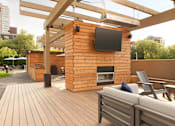 Thumbnail 9 of 21 - A wooden deck with a TV mounted on a wooden wall at Skye at Belltown Apartments, Seattle, Washington