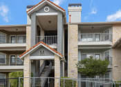 Thumbnail 34 of 35 - an apartment building with stairs and a stair case in front