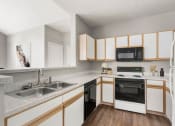 Thumbnail 5 of 29 - a kitchen with white cabinets and black appliances at Veranda at Centerfield, Houston, TX