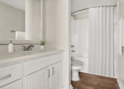 Thumbnail 11 of 28 - a bathroom with a shower and a sink and a toilet at Villages of Cypress Creek, Houston