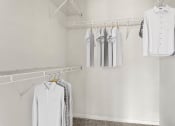 Thumbnail 6 of 28 - a white closet with white shirts hanging on a rack at Villages of Cypress Creek, Texas, 77070