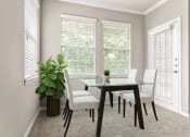 Thumbnail 3 of 28 - a dining room with a table and chairs and two windows at Villages of Cypress Creek, Houston, Texas