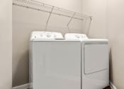 Thumbnail 7 of 28 - a washer and dryer in a room with a rack on the wall at Villages of Cypress Creek, Texas, 77070
