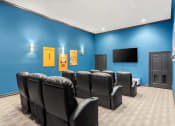 Thumbnail 21 of 28 - our theater room with a blue wall and chairs at Villages of Cypress Creek, Houston