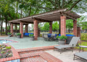 Thumbnail 16 of 28 - a gazebo with tables and chairs next to a swimming pool at Villages of Cypress Creek, Houston, TX, 77070