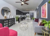Thumbnail 2 of 22 - a view of a living room with chairs and a table at District West Gables, West Miami, FL