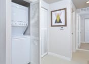 Thumbnail 6 of 22 - a white room with a bathroom and a closet at District West Gables, West Miami, 33155