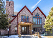 Thumbnail 33 of 33 - the front of a large brick building with snow on the ground  at The links at Plum Creek Apartments, Castlerock, CO 80104