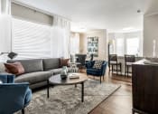Thumbnail 16 of 33 - a living room with a couch and a table at The links at Plum Creek Apartments, Castlerock, CO