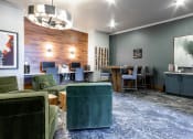 Thumbnail 27 of 33 - a living room with green furniture and a blue rug at The links at Plum Creek Apartments, Castlerock, CO 80104