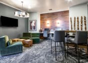 Thumbnail 26 of 33 - a living room with a bar and a dining room at The links at Plum Creek Apartments, Castlerock Colorado