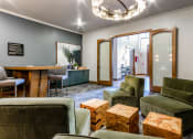 Thumbnail 25 of 33 - a living room with green couches and chairs and a table at The links at Plum Creek Apartments, Castlerock, 80104