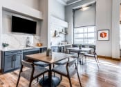 Thumbnail 22 of 33 - a dining room with a table and chairs and a kitchen with a tv at The links at Plum Creek Apartments, Castlerock Colorado