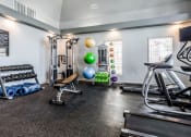 Thumbnail 30 of 33 - fitness room with weights and other exercise equipment at The links at Plum Creek Apartments, Colorado, 80104