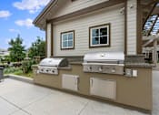 Thumbnail 82 of 105 - A beige outdoor kitchen with a grill and sink.