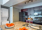Thumbnail 3 of 17 - full kitchen with stainless steel appliances and granite counter tops and a sink at Skyview Apartments, Westminster, CO 80234
