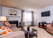 Thumbnail 6 of 17 - a living room with a couch and a chair and a television at Skyview Apartments, Westminster Colorado