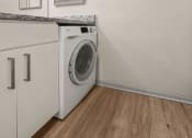 Thumbnail 16 of 31 - a front loading washer and dryer in a laundry room with a counter top at South Lamar Village, Texas