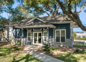 Thumbnail 24 of 31 - a small house with a sidewalk and trees in front of it at South Lamar Village, Austin, Texas