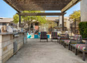 Thumbnail 22 of 31 - a outdoor patio with a grill and chairs at South Lamar Village, Austin, TX