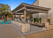 Thumbnail 21 of 31 - a patio with a bar and chairs in front of a house at South Lamar Village, Austin, Texas
