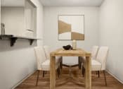 Thumbnail 10 of 31 - a dining room with a wooden table and white chairs at South Lamar Village, Austin