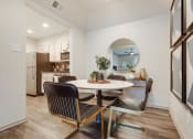 Thumbnail 3 of 35 - a dining room with a table and chairs and a kitchen