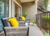Thumbnail 10 of 35 - a balcony with a couch and chairs on it