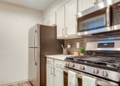 Thumbnail 5 of 35 - Kitchen with fridge and stove