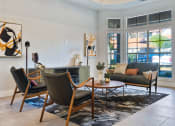 Thumbnail 28 of 35 - a living room with a couch and chairs and a fireplace