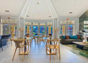 Thumbnail 23 of 35 - the living room and dining room of a house with tables and chairs