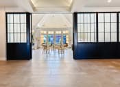 Thumbnail 25 of 35 - a dining room with black sliding doors and a table and chairs