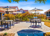 Thumbnail 33 of 35 - an outdoor patio with tables and umbrellas