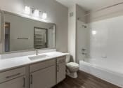 Thumbnail 16 of 35 - a bathroom with a toilet sink and shower and a mirror