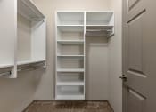 Thumbnail 17 of 35 - a walk in closet with white shelves and