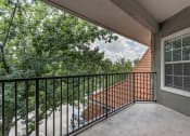 Thumbnail 20 of 35 - the balcony has a view of the trees and the house