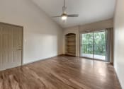 Thumbnail 12 of 35 - an empty living room with wood flooring and a window