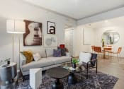 Thumbnail 5 of 19 - a living room with a couch and a table at The Olivine, Texas