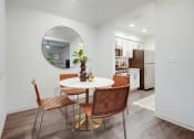 Thumbnail 4 of 19 - a living room with a table and a mirror in it at The Olivine, Texas, 78727