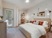 Thumbnail 8 of 19 - a bedroom with a bed and a door to a closet at The Olivine, Austin, Texas