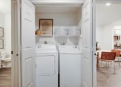 Thumbnail 11 of 19 - a washer and dryer in a white laundry room at The Olivine, Austin